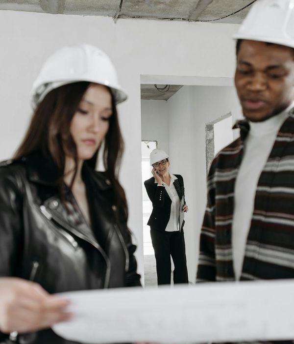 Professional woman architect reviewing interior design blueprints at workspace